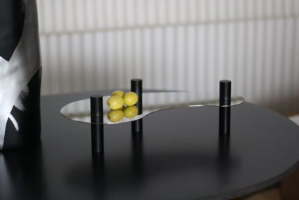Stellar Arc Stainless Steel & Black Metal Tray – modern arched tray with black metal cylindrical legs.