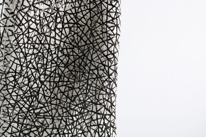 Textured artisan vase with cracked surface design and flowing silhouette – handcrafted decorative object for modern homes
