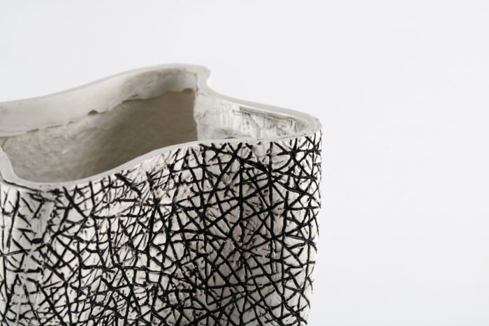 Textured artisan vase with cracked surface design and flowing silhouette – handcrafted decorative object for modern homes