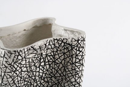 Textured artisan vase with cracked surface design and flowing silhouette – handcrafted decorative object for modern homes