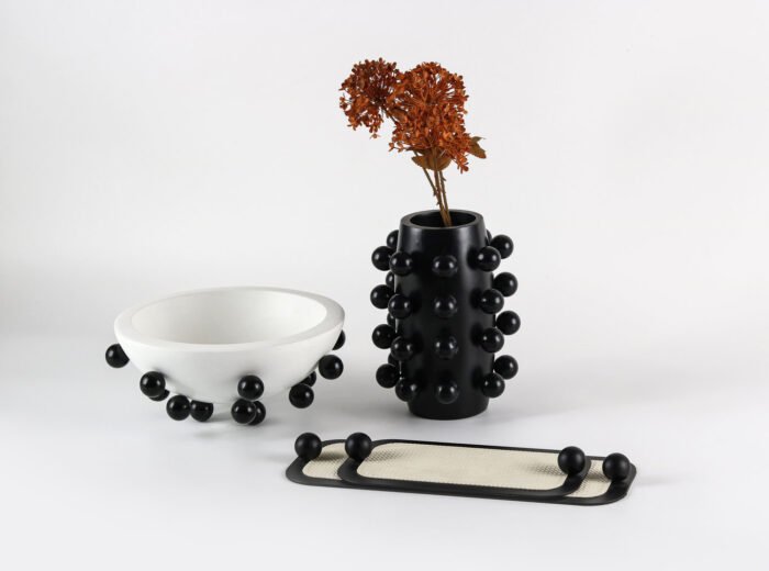 Sleek Minimal Tray with Black Accents – cream leather tray with black border and sculptural handles.