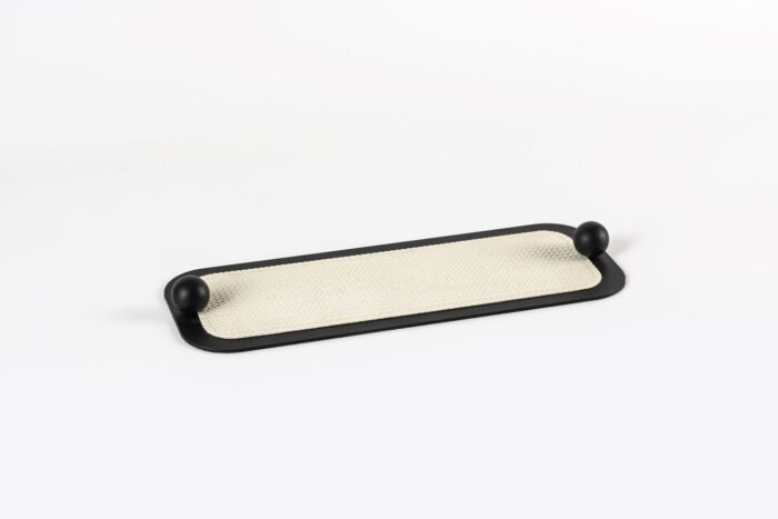 Sleek Minimal Tray with Black Accents – cream leather tray with black border and sculptural handles.