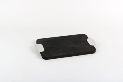 Black serving tray with silver handles styled with modern decor.