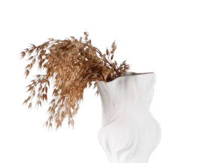 White flowing vase with sculptural soft curves and matte finish, styled with dried grass for minimalist and calming interior design.