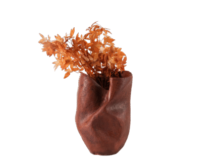 Sculptural red vase with a matte twisted silhouette, styled with warm dried florals for artistic modern home decor.